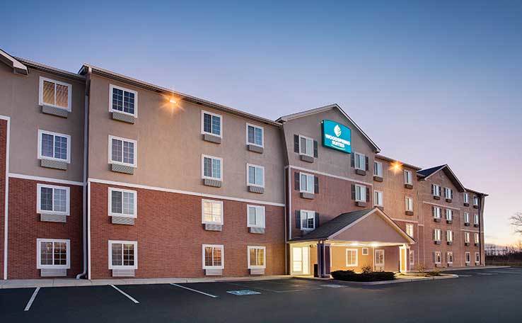 WoodSpring Suites Fort Wayne Extended Stay Hotel Evening Exterior 1 738x456~800