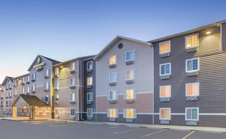 WOODSPRING SUITES SIOUXFALLS EXTENDED STAY HOTEL EXTERIOR DUSK 2 738X456~800
