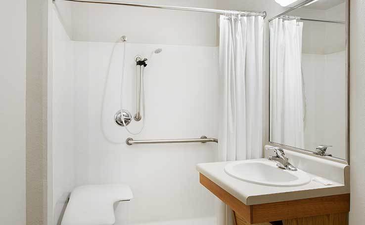 Extended Stay Hotel In Jacksonville FL WoodSpring Suites   WoodSpring Suites Extended Stay Hotel Rebrand Carpet Generic ADA Bathroom Transfer Shower 738x456~800 