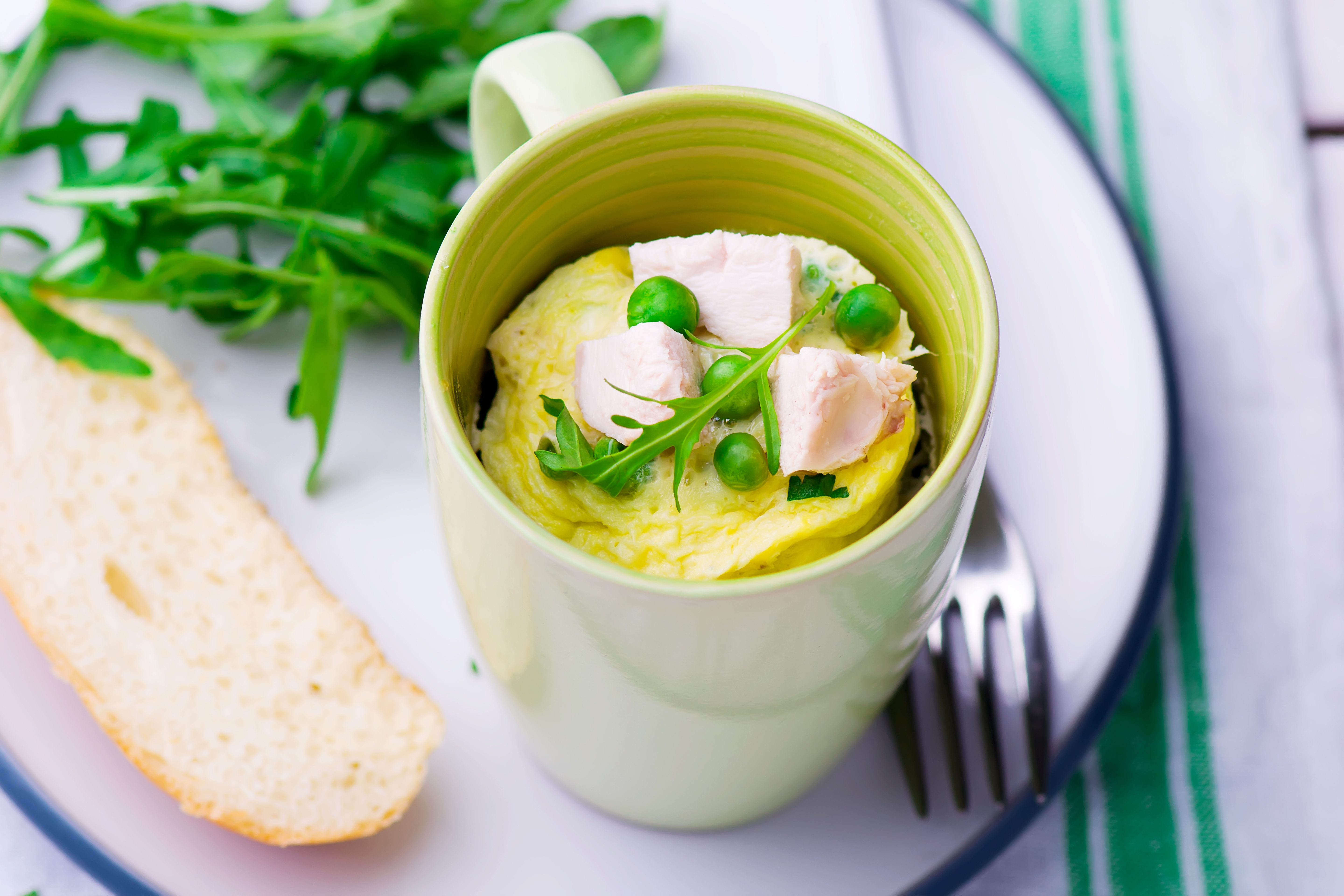Microwave-prepared mug omelet with fresh toppings.