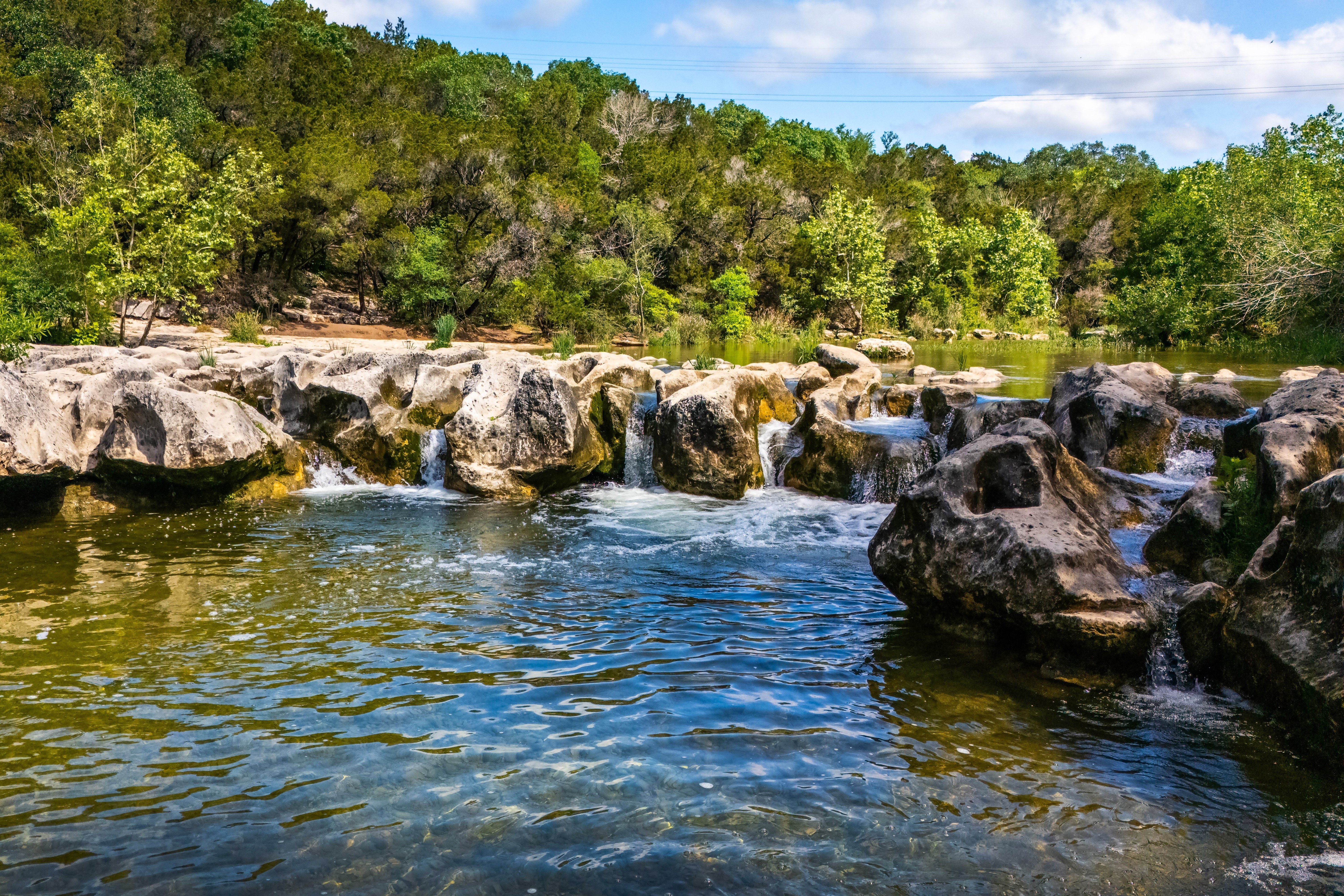 Clear water flowing over rocks at Sculpture Falls in Austin.
